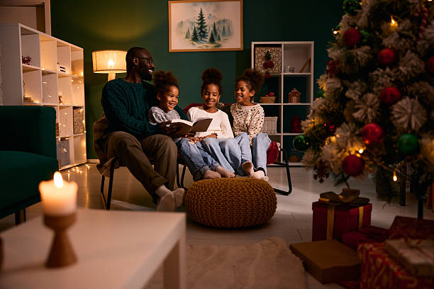 istock Father reading Christmas story to laughing daughters 2236045166