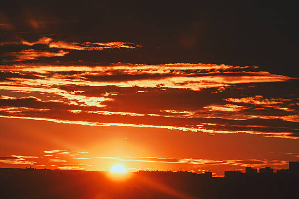 istock Sunset illuminates sky over distant city 2236047991