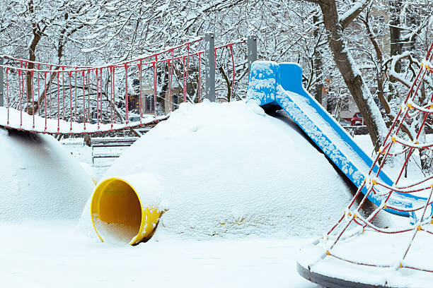 frozen park Eastern Europe metallic carousel amusement place abandoned idyllic view with white snowy cover