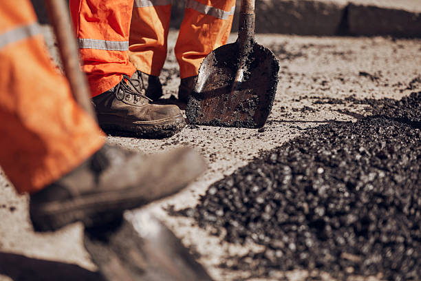 istock Construction workers working on a new asphalt layer on a public street. 2236049069