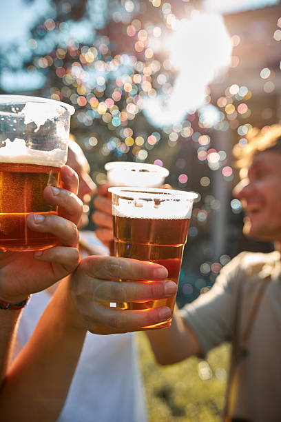 istock People holding beer cups and enjoying summertime outdoors. 2236049708