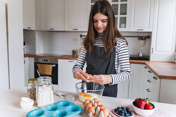 istock Young Girl Cooking with Eggs in a Modern Kitchen 2236049940