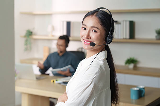 istock Confident Call Center Agent Smiling at Camera in Office 2236052717