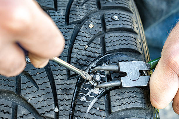istock Person fixing tire spike with simple tools 2236055516
