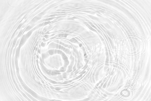 istock White water with ripples on the surface. Defocus blurred transparent white colored clear calm water surface texture with splashes and bubbles. Water waves with shining pattern texture background. 2236056336