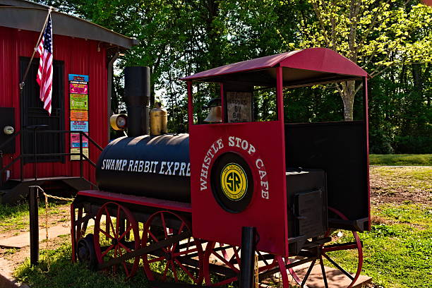 Travelers Rest, SC  April 21, 2025: A small trail engine, The Swamp Rabbit Express, is a fun decoration outside the Whistle Stop Café in Travelers Rest.