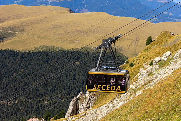 Ortisei, Italy - September 29, 2024: Cable car arriving to Seceda in Val Gardena, Dolomites Alps, summer autumn landscape