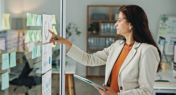 istock Professional Woman Analyzing Business Data on Glass Board in Modern Office 2236059583