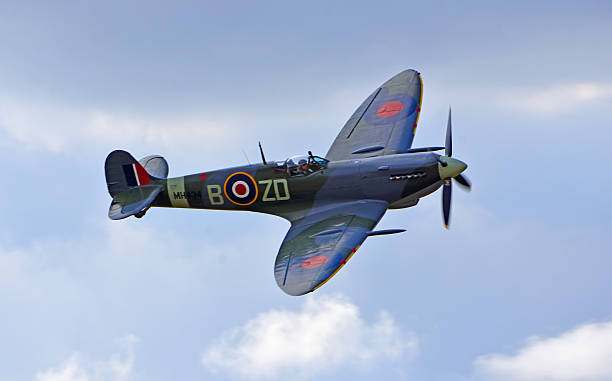 Little Gransden, Cambridgeshire, England - August 24, 2025: Vintage Supermarine Spitfire aircraft in flight cloudy sky