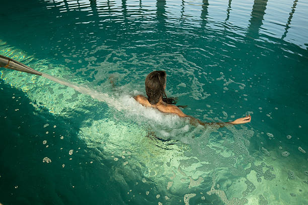 woman relaxing in a thermal bath enjoying a hydromassage
