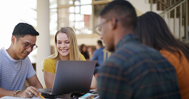 istock People, students and laptop on campus for university portal, check exam results or assignment with friends. Pc, man and woman with group outdoor for learning, online academic study or research 2236063134
