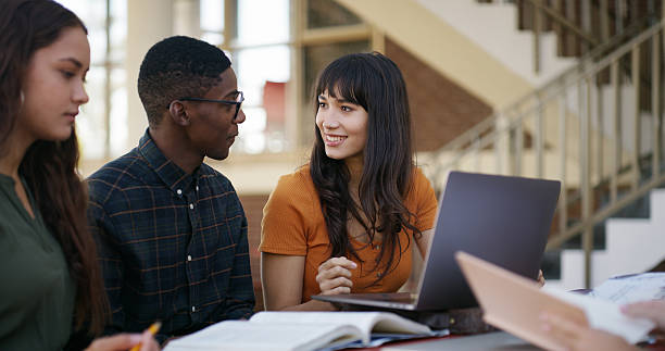 istock Students, books and study group with laptop at university for exam preparation, assignment and help. Education, people and tech on campus for assessment discussion, tutorial research and scholarship 2236063186