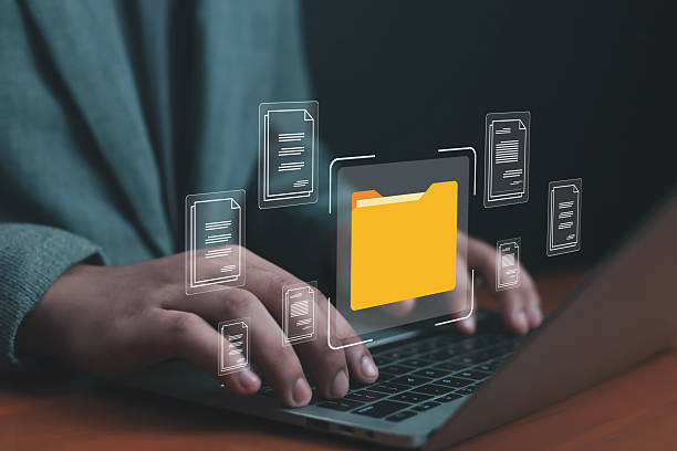 istock Person typing on laptop with digital folder and document icons, representing cybersecurity, cloud computing, online data storage, file sharing, and secure information management system cloud storage 2236064355