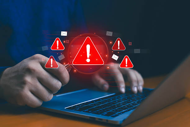 istock Hands typing on laptop with multiple red warning icons, concept of phishing attack, malware infection, email scam, cybersecurity threat, data breach, hacking risk, and online information protection. 2236064720