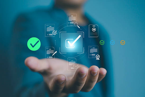 istock Businessman hand holding digital check mark icon with documents, concept of online approval, electronic signature, workflow automation, data validation, compliance, and secure business process. 2236064787