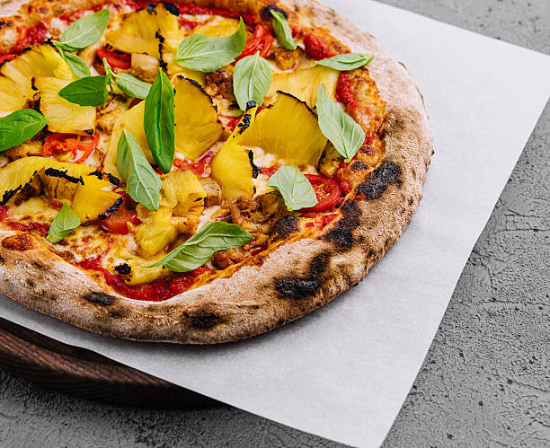 Fresh hawaiian pizza on wooden board