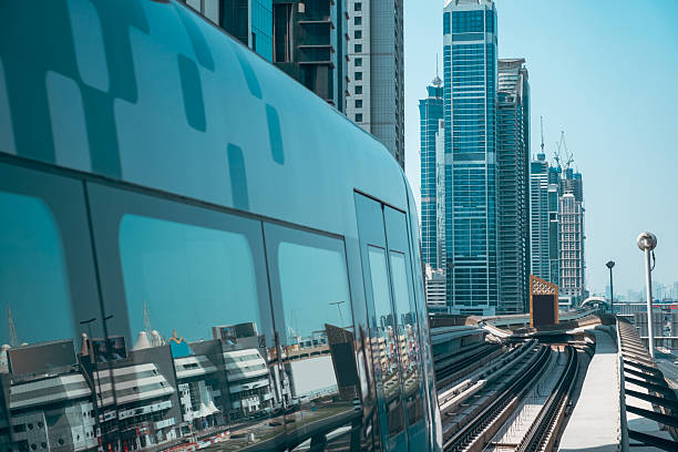 istock Modern glass skyscrapers dominate the urban skyline, reflecting the blue sky and a train passing by a high steel station in a busy city like Shanghai or Dubai 2236070338