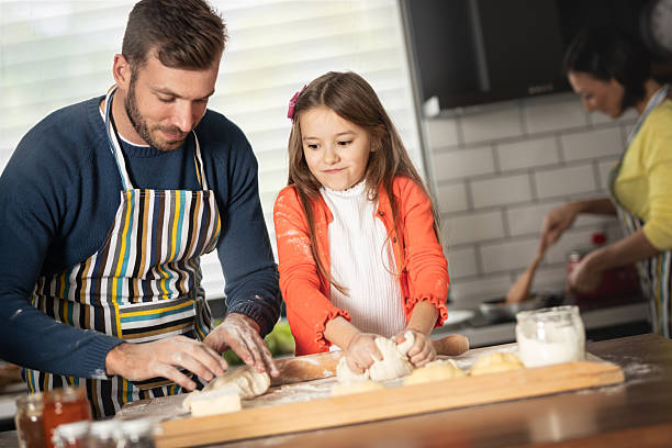istock A child helps the father in the kitchen 2236071159