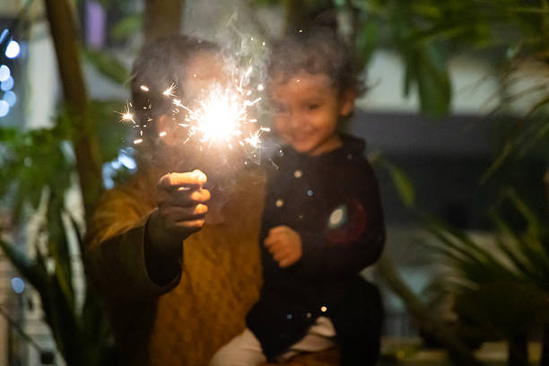 istock festive firework sparklers with joyful blurred father and son moment 2236076873