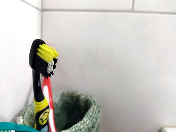 istock Brightly colored toothbrush standing in bathroom holder 2236080304