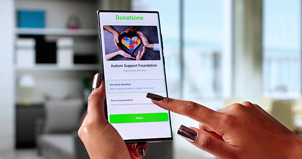 istock Generous Young Woman Using Her Smartphone To Donate 2236081490