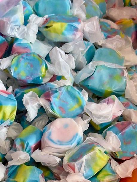 A bin with colorful salt water taffy candy for sale at a seaside candy store