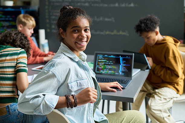 Portrait of Teenage Black Girl Smiling While Learning Coding in Classroom