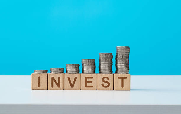 istock Stack of coins on word invest 2236084234