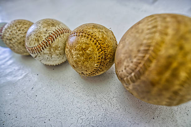 Three baseballs sitting on the beach for the Grapefruit League in Florida for Spring Training, with palm trees and ocean in the background