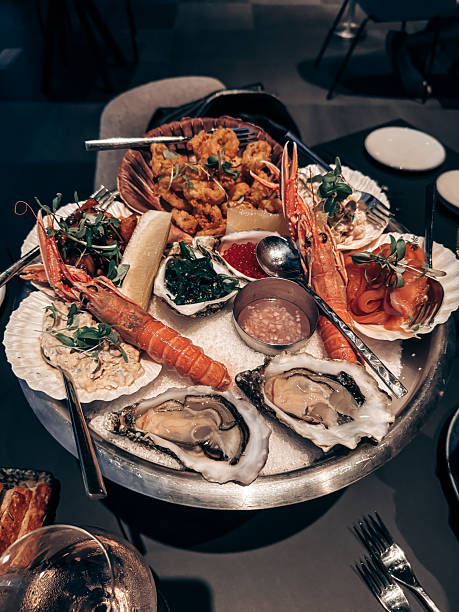 istock A large seafood platter is served at an upscale restaurant, showcasing fresh oysters, shrimp, and other seafood delights garnished with green herbs 2236090231