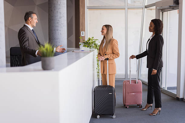 istock Businesswomen checking in at hotel reception 2236090493