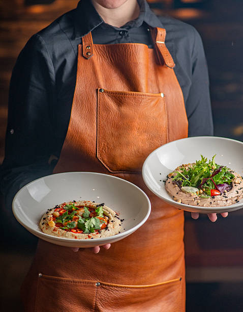 istock Unrecognizable Waiter in apron holding restaurant dishes dishes in his hands 2236090801