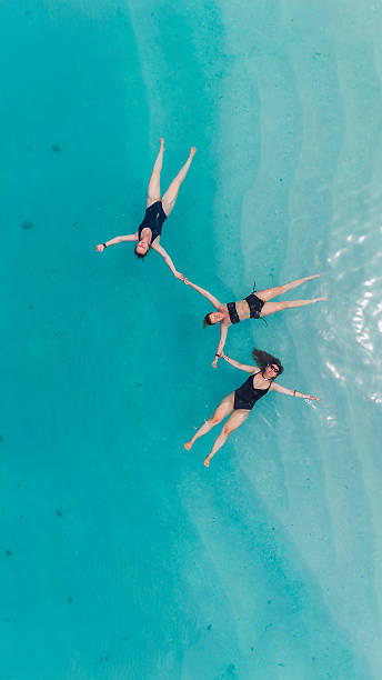 istock Holding Hands Together in Crystal Blue Ocean 2236091216