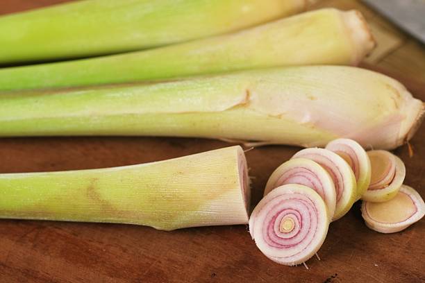 Close-up of sliced lemongrass stalks on wooden board, aromatic herb widely used in Asian cuisine and tea.