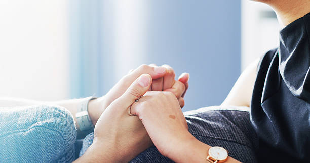 istock Home, couple and holding hands for love, support and connection with partner for commitment. Trust, care and people together for comfort, bonding and loyalty in marriage for relationship in house 2236094125