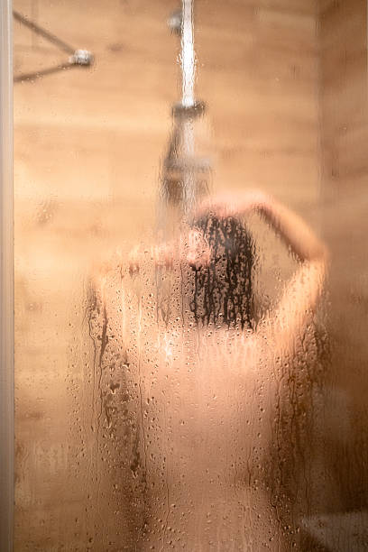 istock Woman taking a shower in bathroom 2236094143