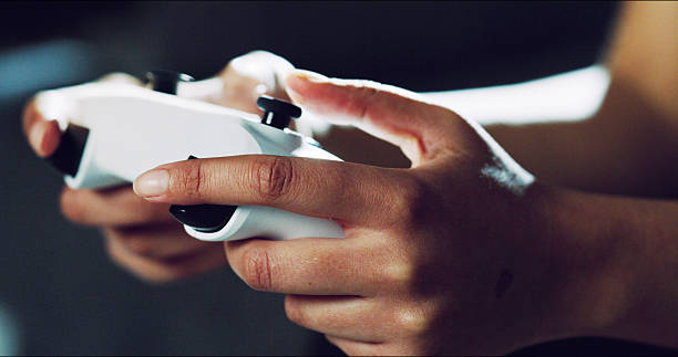 istock Hands, closeup and video game controller in home for esports challenge, click and strategy for next level. Person, gamer and console with tech, joystick and online contest with battle at apartment 2236094184