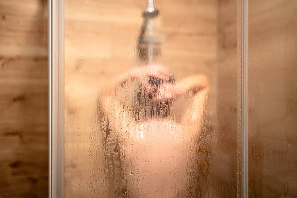 istock Woman taking a shower in bathroom 2236094225