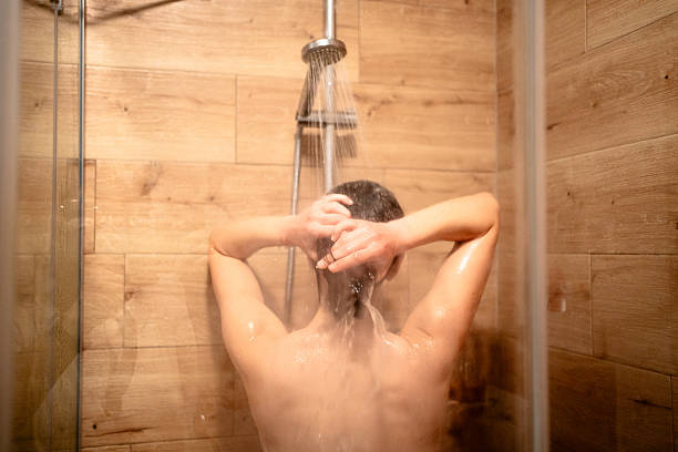 istock Woman taking a shower in bathroom 2236094284