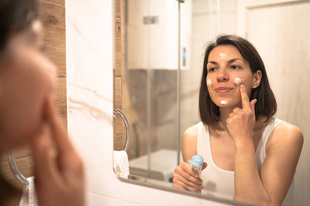 istock Beautiful woman using beauty cosmetics on face. 2236095252