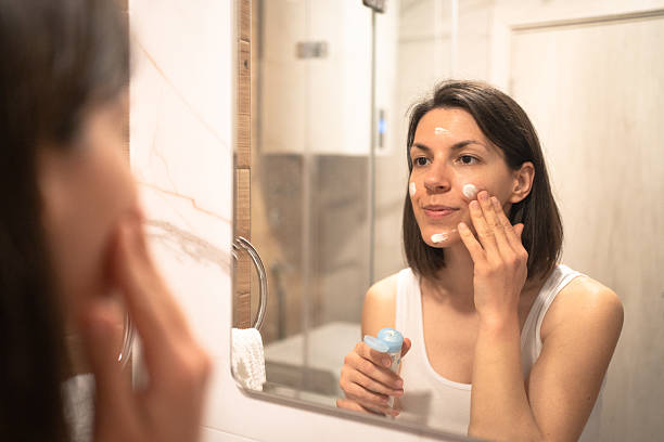 istock Beautiful woman using beauty cosmetics on face. 2236095303