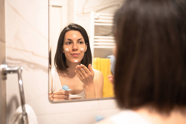 istock Beautiful woman using beauty cosmetics on face. 2236095412