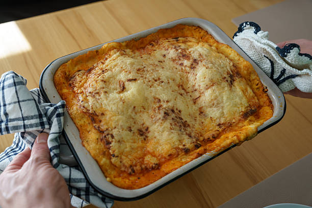 istock Man holding a baked lasagna in a casserole dish 2236095975