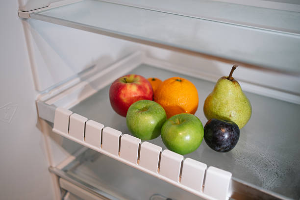 Various types of fruits stored inside a refrigerator.