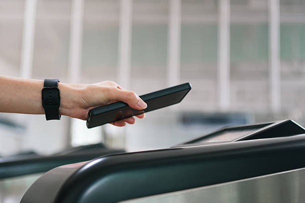istock Person using a smartphone for contactless payment at a train station gate. 2236096672