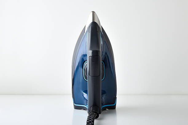 istock Steam iron vertically showing handle and temperature selector on top 2236096842