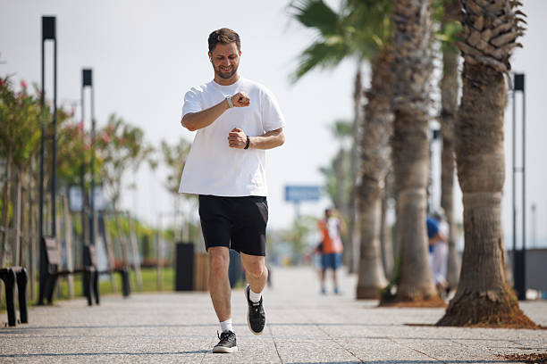 Active man monitoring workout progress on smartwatch