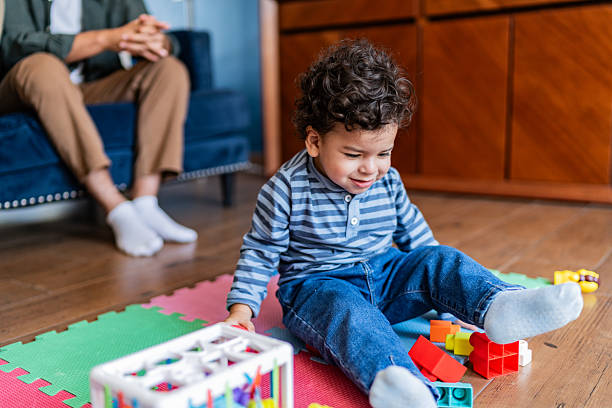 istock Baby boy playing with toys at home 2236097128
