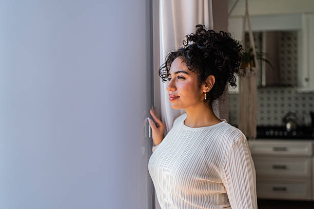 istock Young woman contemplating at home 2236100231