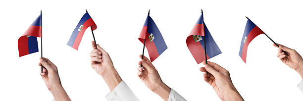 The Haiti flag in hand in different angles on a white background.